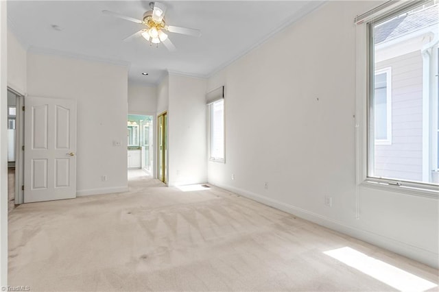 unfurnished room with baseboards, carpet floors, ceiling fan, and ornamental molding