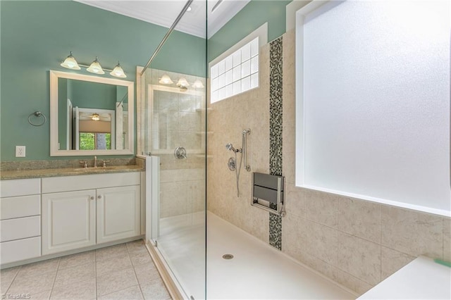 bathroom featuring tile patterned floors, vanity, and a tile shower