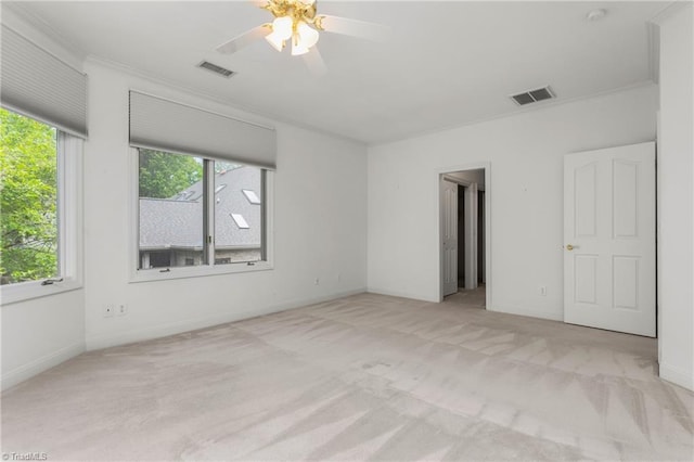 unfurnished bedroom with baseboards, visible vents, carpet, and crown molding