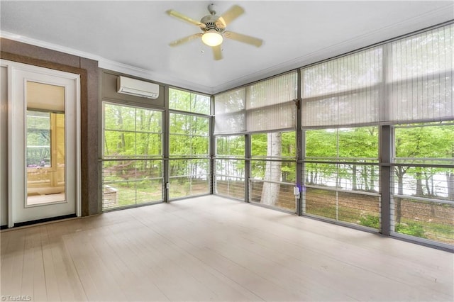 unfurnished sunroom with an AC wall unit and ceiling fan