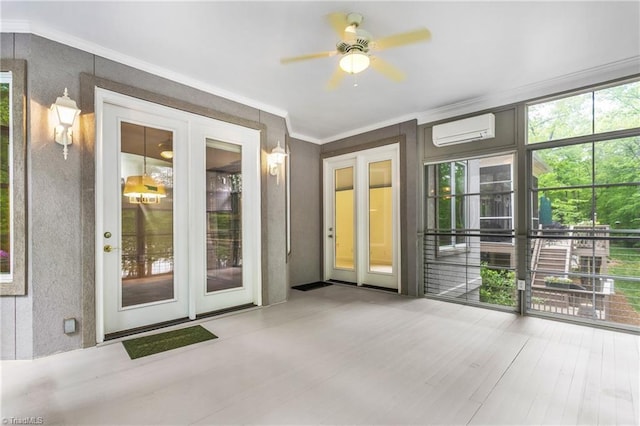 interior space with wood finished floors, ornamental molding, ceiling fan, and a wall mounted air conditioner