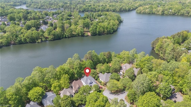 aerial view featuring a forest view, a water view, and a residential view