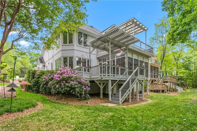 back of house with a pergola, a sunroom, stairs, and a deck