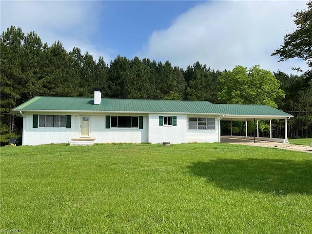 1024 Lone Hickory Rd, Yadkinville, NC 27055 - rear view of house featuring a chimney, a carport, a lawn, and metal roof