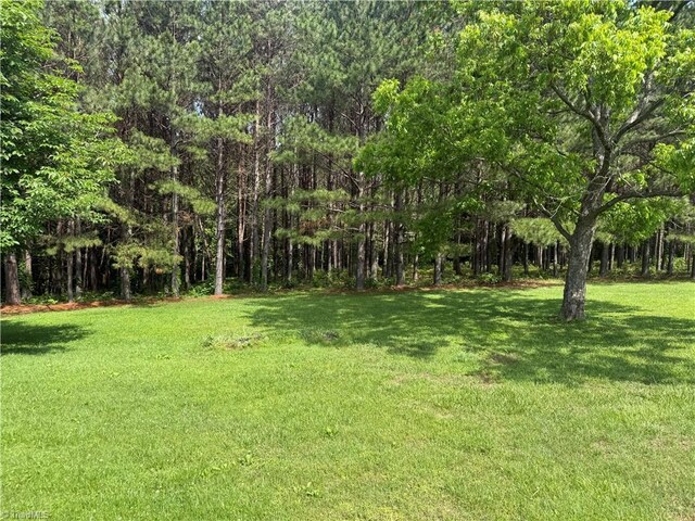 1024 Lone Hickory Rd, Yadkinville, NC 27055 - view of grassy yard with a wooded view