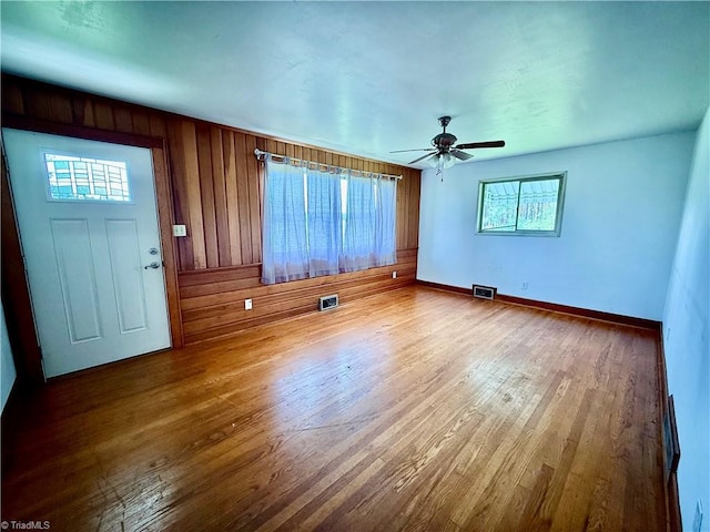 1024 Lone Hickory Rd, Yadkinville, NC 27055 - empty room with wood finished floors, a ceiling fan, baseboards, and wood walls