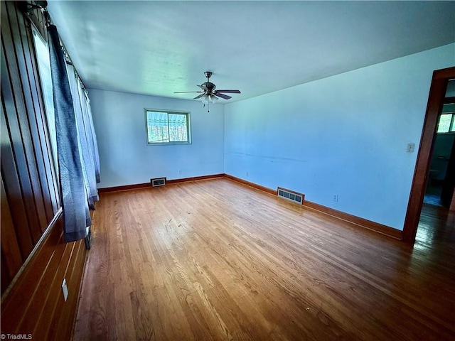 1024 Lone Hickory Rd, Yadkinville, NC 27055 - empty room with wood finished floors, a ceiling fan, and baseboards