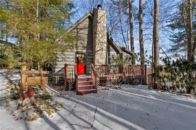 view of front facade with a chimney and a wooden deck