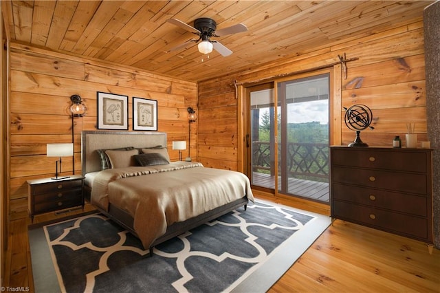 bedroom featuring wooden walls, wooden ceiling, wood finished floors, and access to exterior