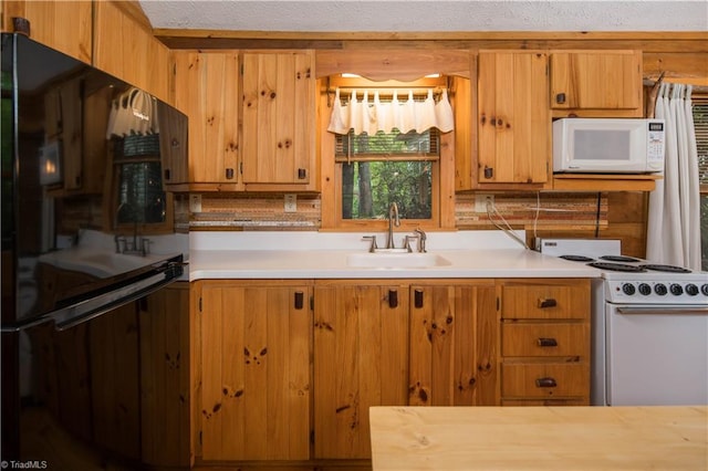 kitchen featuring sink and white appliances