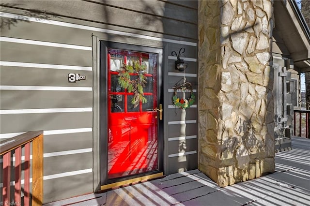 property entrance with stone siding