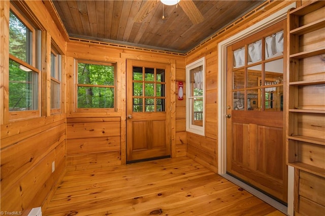 entryway featuring light wood-style flooring, wooden ceiling, wooden walls, and a sauna