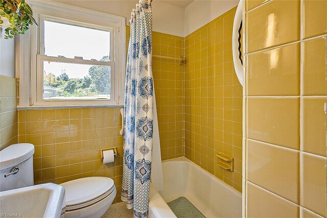 bathroom featuring tile patterned floors, decorative backsplash, tile walls, and toilet