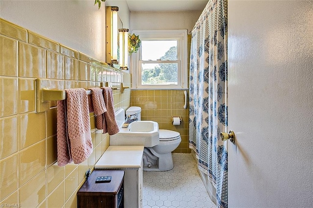 bathroom with tile walls, tile patterned flooring, and toilet