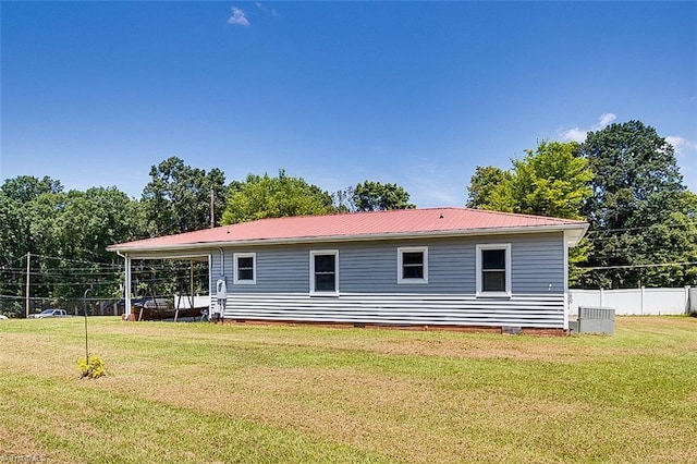 rear view of house featuring a yard