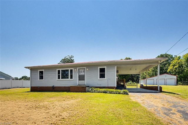 view of front of home with a carport, an outbuilding, a garage, and a front yard