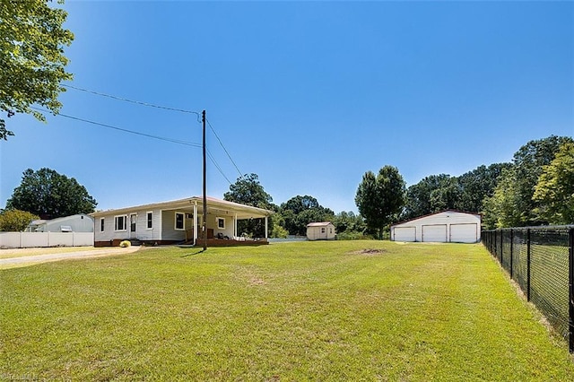 view of yard with a garage and an outdoor structure