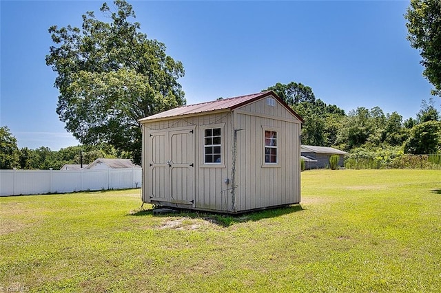 view of outbuilding featuring a lawn