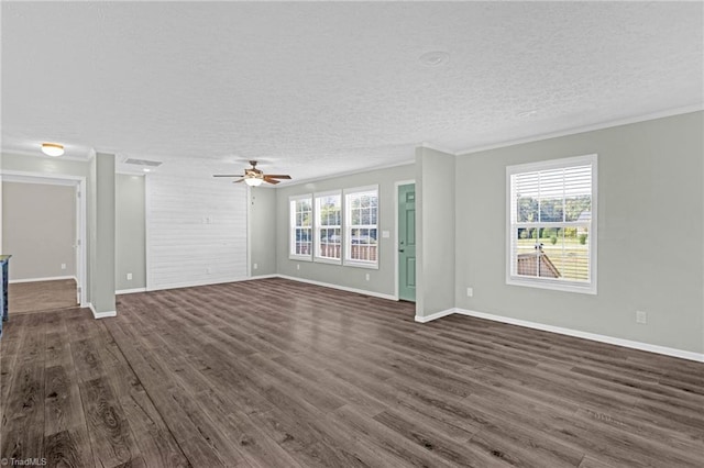 unfurnished living room with ceiling fan, dark hardwood / wood-style floors, a textured ceiling, and a healthy amount of sunlight