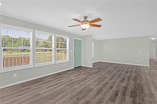 interior space featuring plenty of natural light, dark hardwood / wood-style floors, crown molding, and ceiling fan