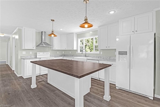 kitchen with wall chimney exhaust hood, wooden counters, white fridge with ice dispenser, range with electric cooktop, and stainless steel dishwasher