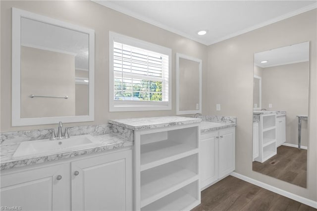 bathroom with ornamental molding, hardwood / wood-style floors, and vanity