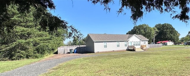 view of side of home featuring a yard