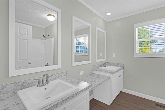 bathroom featuring vanity, crown molding, a textured ceiling, and hardwood / wood-style flooring