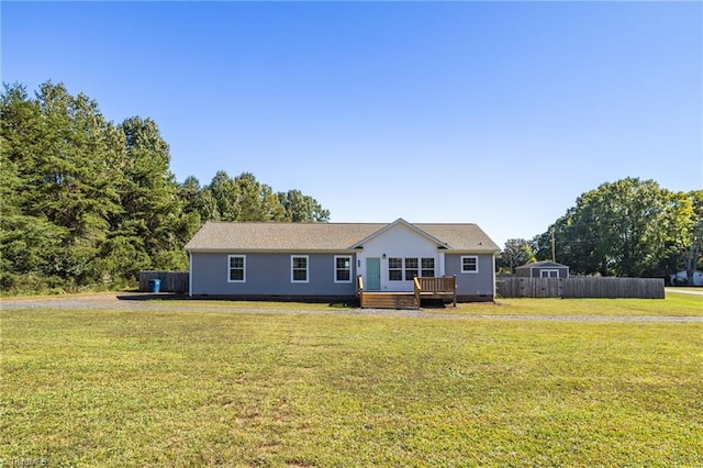 view of front of home featuring a front yard and a deck