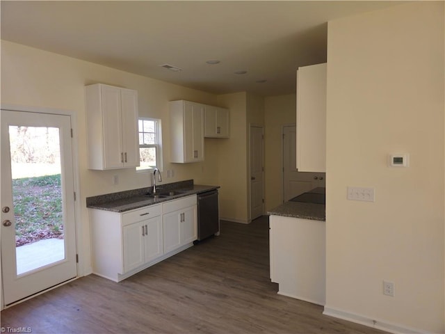 kitchen with black dishwasher, white cabinets, dark hardwood / wood-style floors, and sink