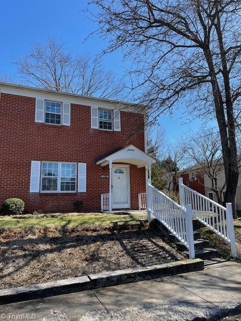 view of front of property featuring brick siding