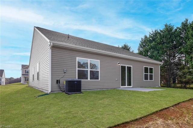 back of house with a patio, central AC unit, and a lawn