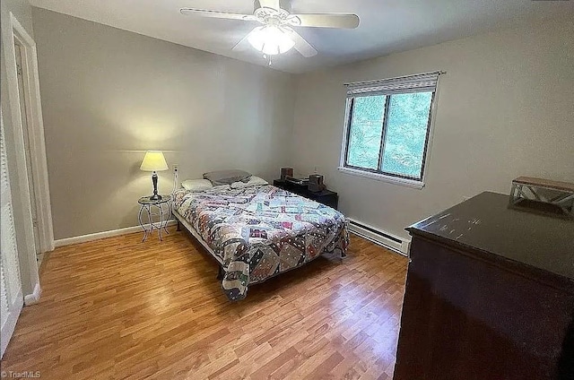 bedroom featuring ceiling fan, hardwood / wood-style floors, and baseboard heating