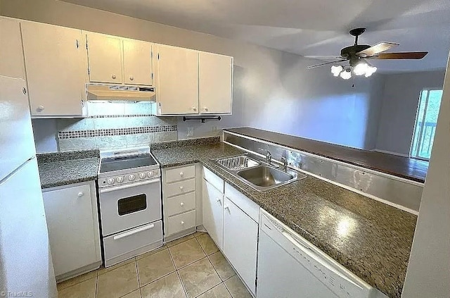 kitchen featuring sink, white cabinetry, light tile patterned floors, white appliances, and backsplash