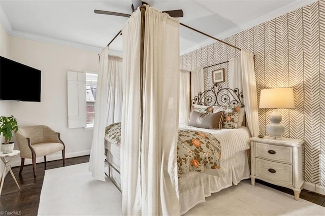 bedroom featuring hardwood / wood-style flooring, ceiling fan, and ornamental molding