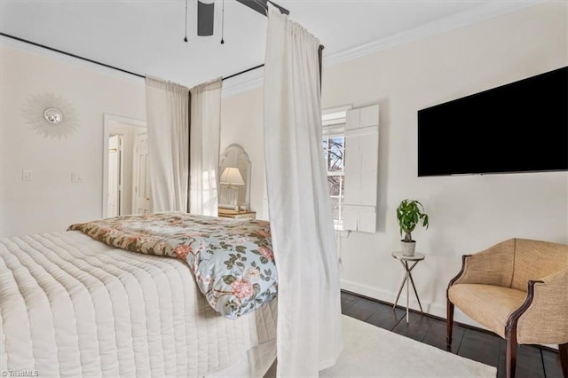 bedroom with crown molding, ceiling fan, and dark hardwood / wood-style flooring