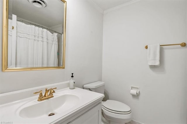 bathroom featuring vanity, ornamental molding, and toilet