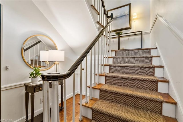 stairs featuring parquet floors