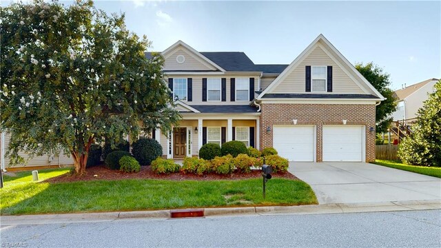 view of front of property with a garage and a front lawn