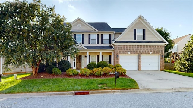 traditional-style home featuring a front yard, fence, an attached garage, concrete driveway, and brick siding