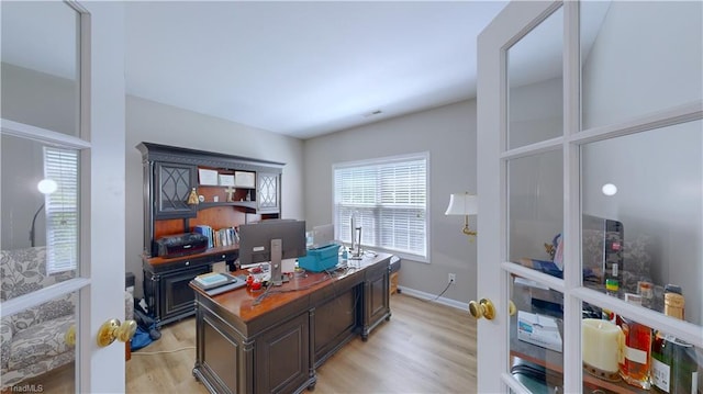 office space featuring light wood-style floors and baseboards