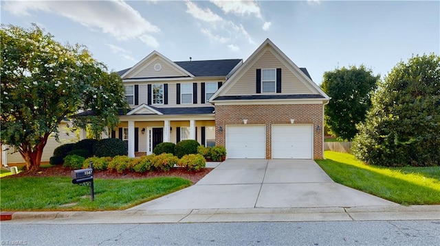 view of front facade with a front lawn, brick siding, and driveway