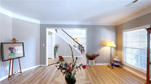 sitting room with light hardwood / wood-style flooring and crown molding