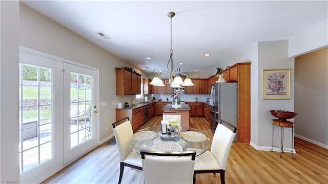 dining area featuring light wood finished floors, a chandelier, recessed lighting, and baseboards