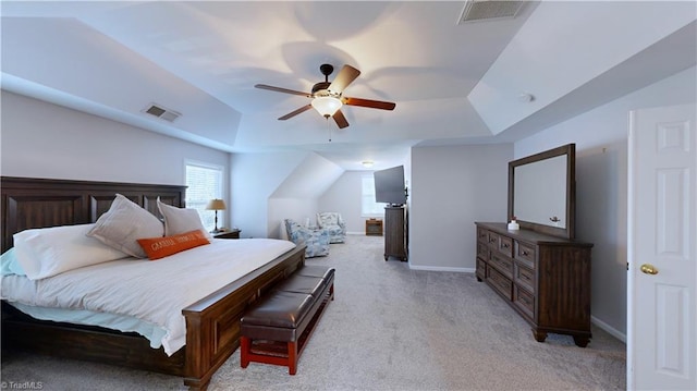 bedroom with visible vents, a raised ceiling, light colored carpet, and baseboards