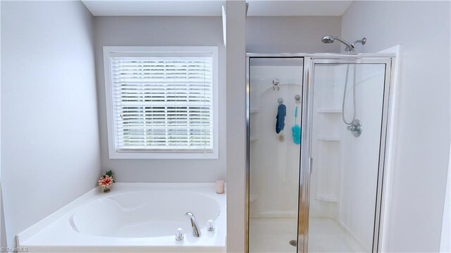 bathroom with separate shower and tub and a healthy amount of sunlight