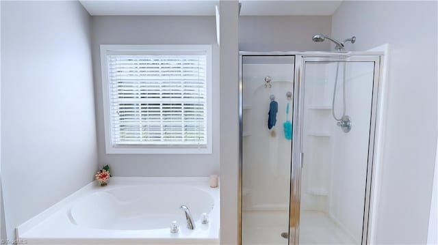 bathroom with a bath and a stall shower