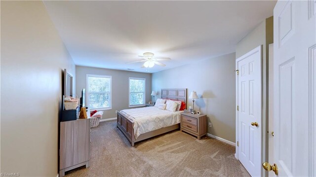 bedroom featuring ceiling fan and light carpet