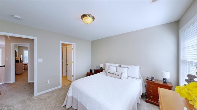 bedroom featuring baseboards and light colored carpet