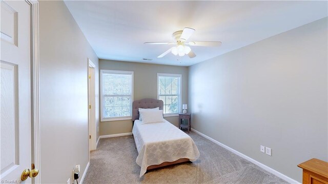 bedroom with ceiling fan and light colored carpet